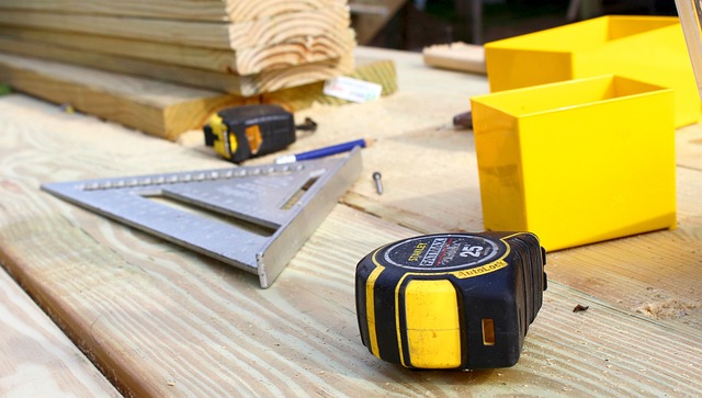 Tape measure, square and marking tools on a workbench alongside a contractor marketing plan