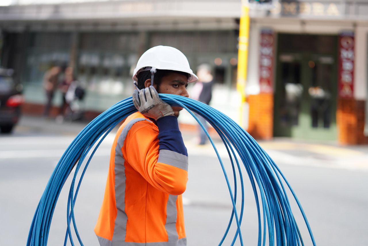 Electrician running cable on a job site — marketing for electrical contractors