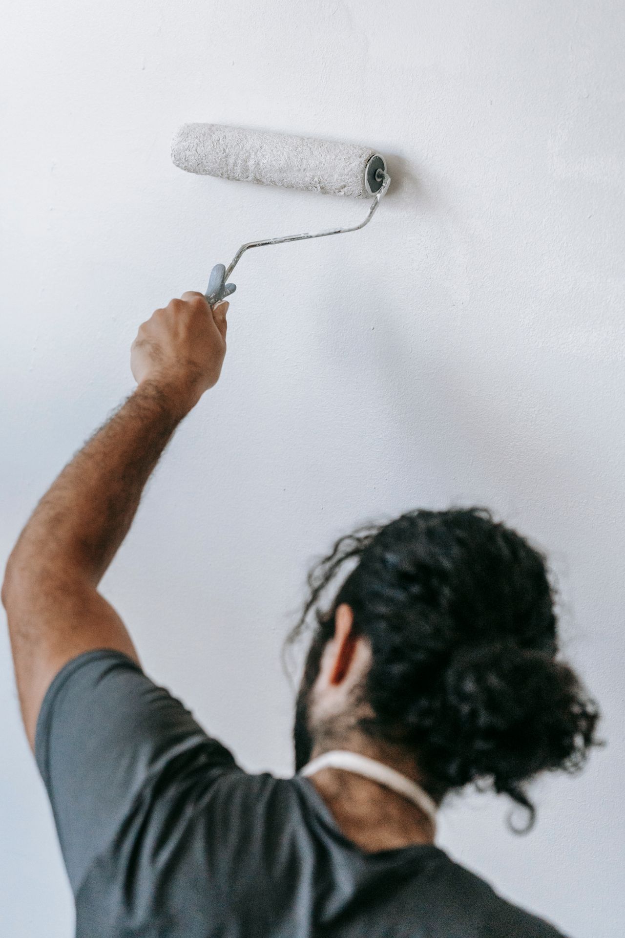 House painter rolling a ceiling — lead generation for painting and trade contractors