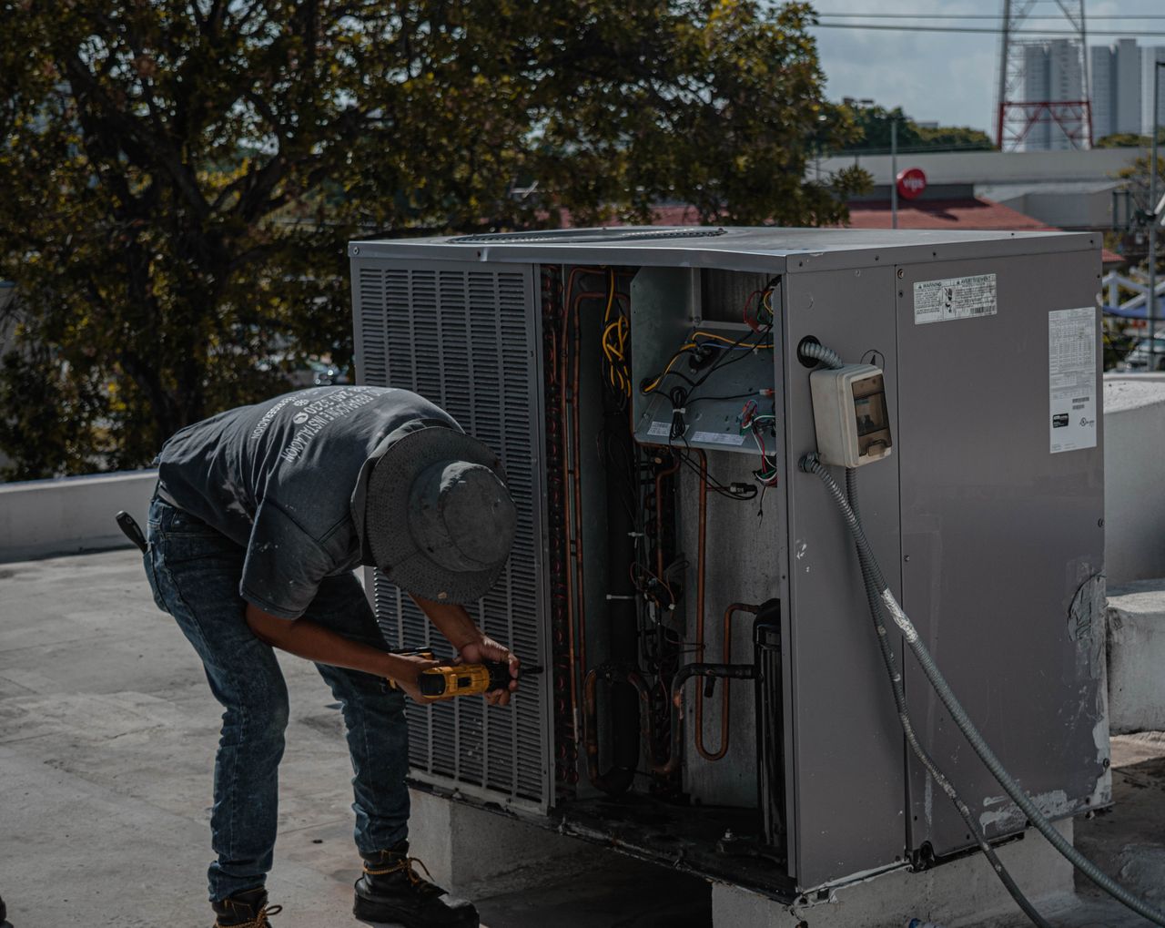 HVAC technician servicing an outdoor condenser unit — marketing for HVAC companies