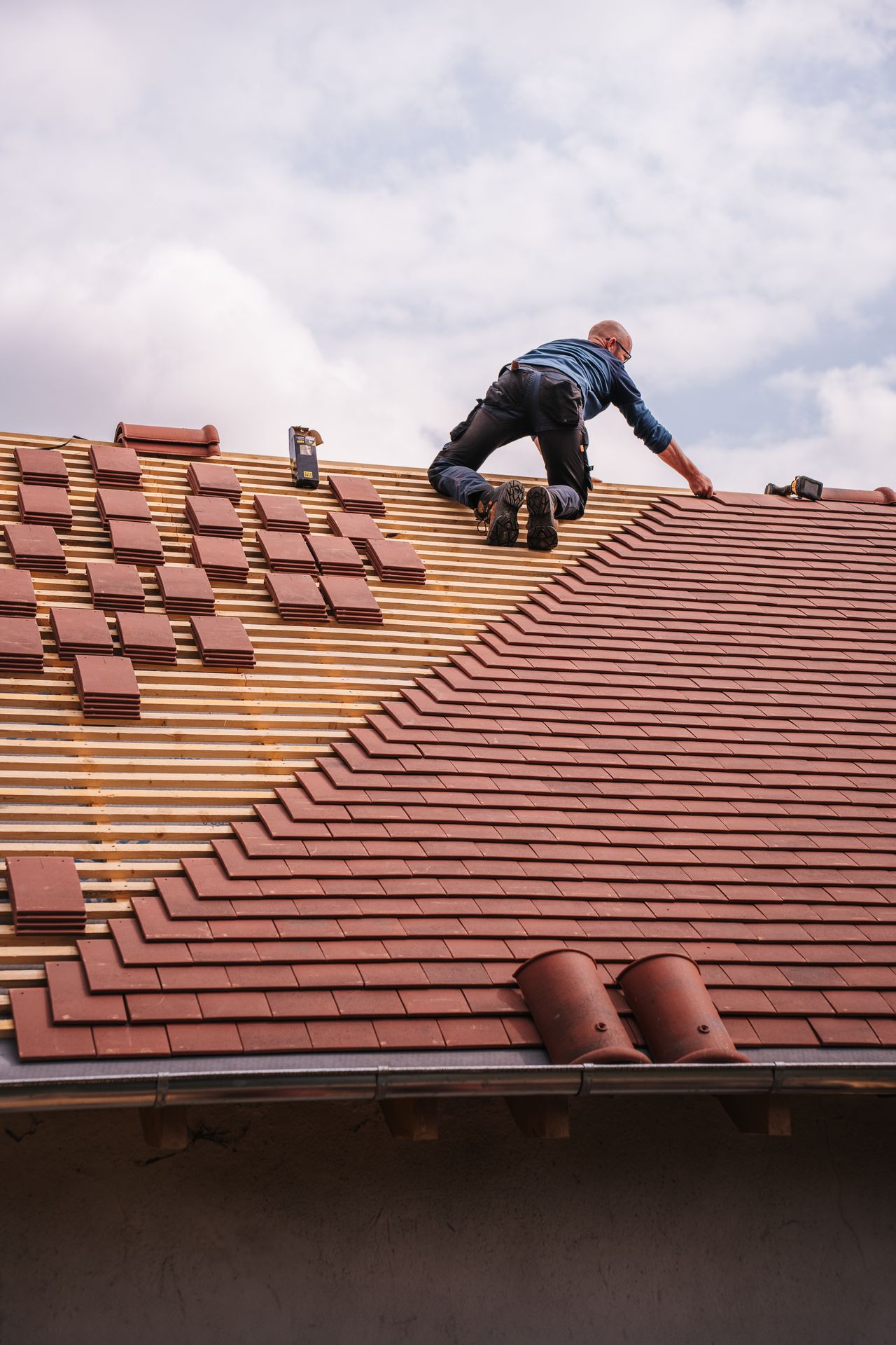 Roofing contractor installing tile roof — marketing and SEO for roofers